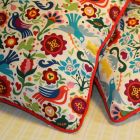 Cushions with bright red contrast piping.